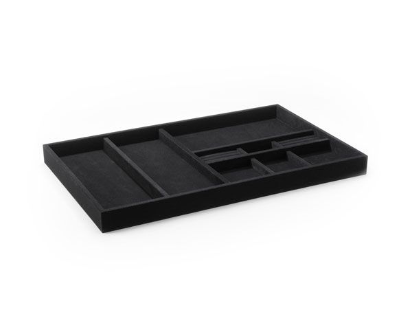 a velveteen black tray with dividers on a white background .