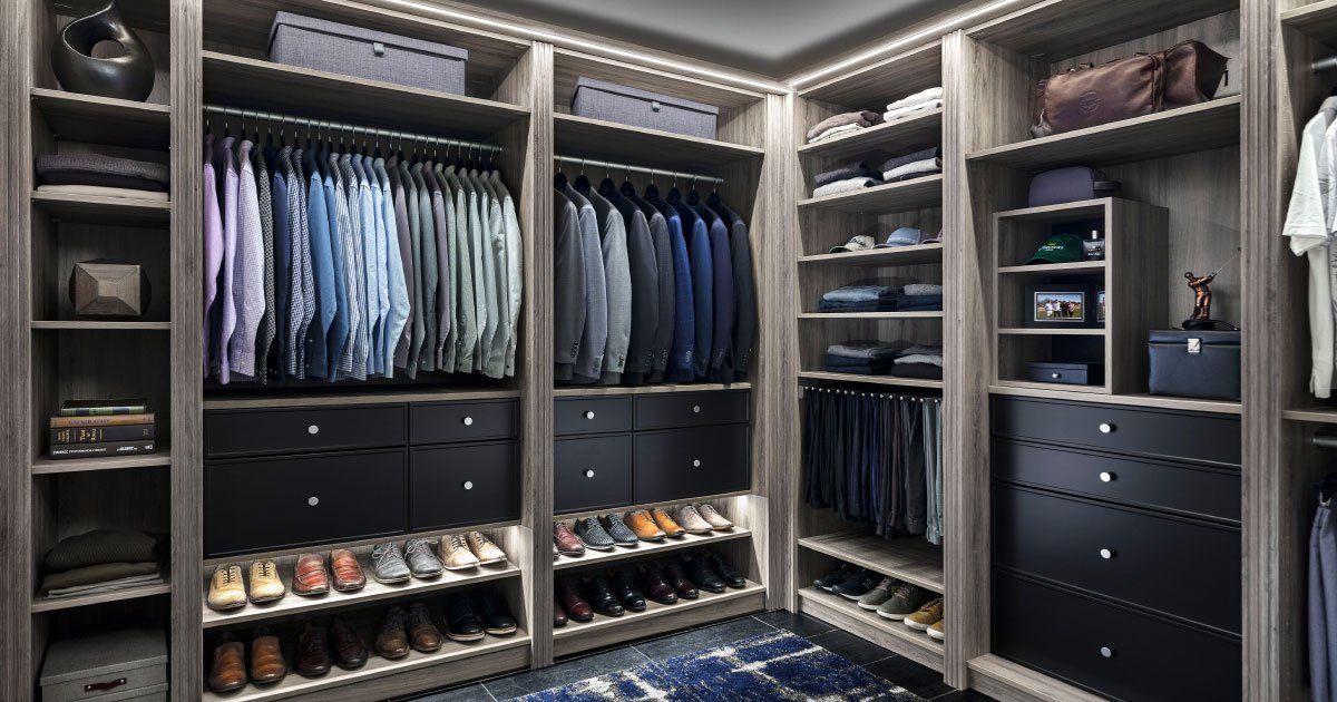 A walk in closet filled with lots of clothes and shoes.