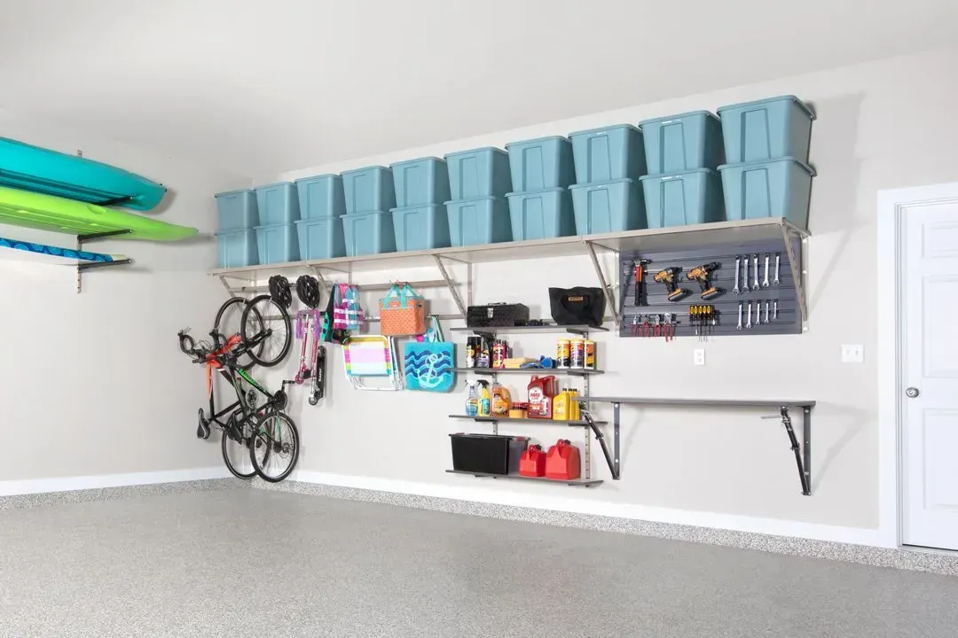 A garage filled with lots of storage space and a bicycle hanging on the wall.
