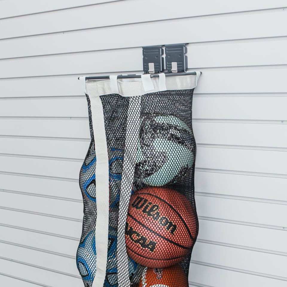 a mesh bag storing an assortment of sports balls