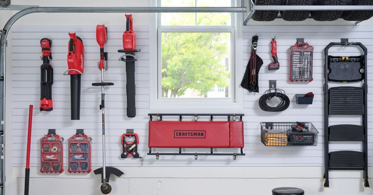 A garage wall with lots of tools hanging on it.