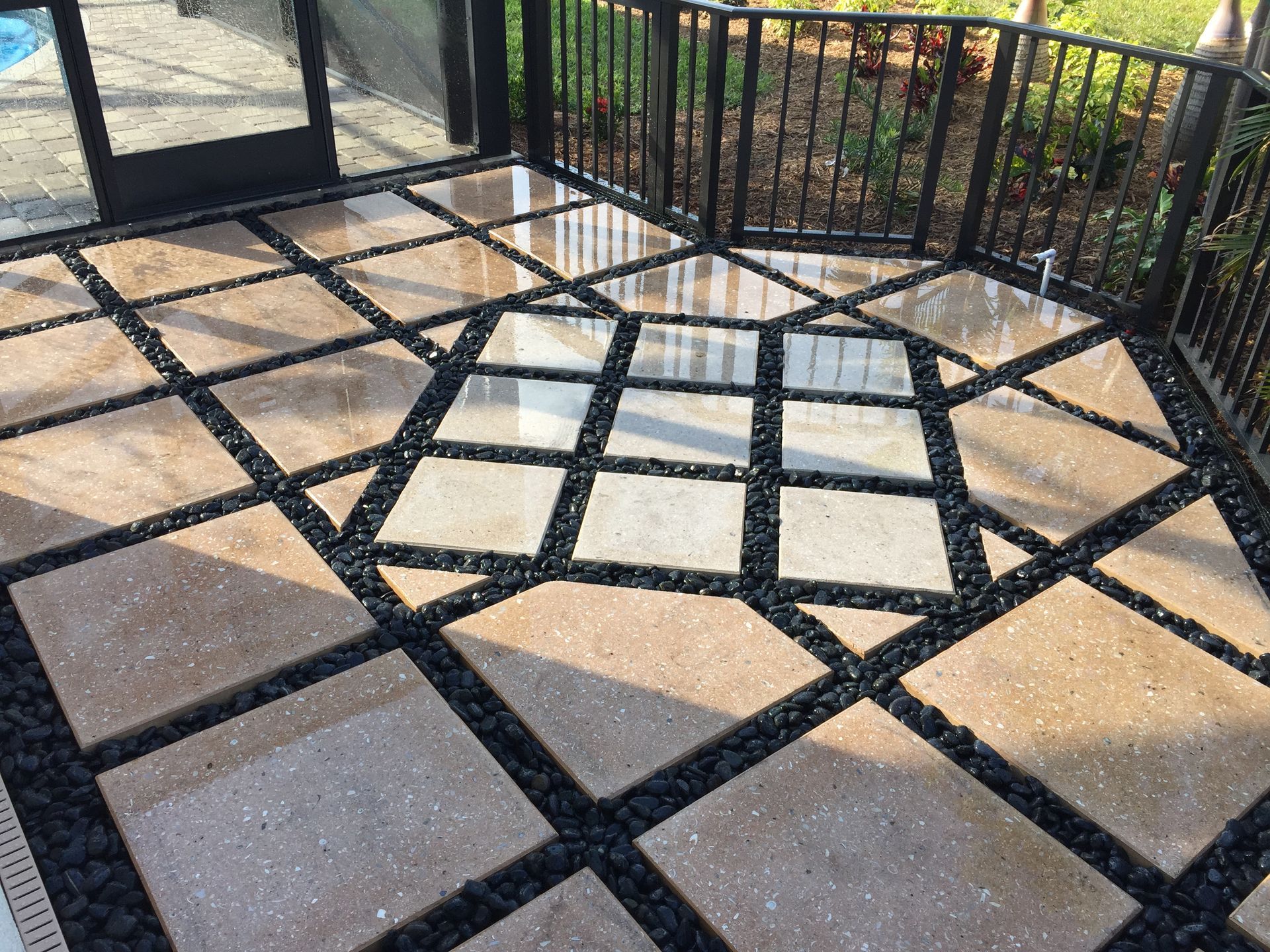 A patio with a fence and a pattern of squares on it