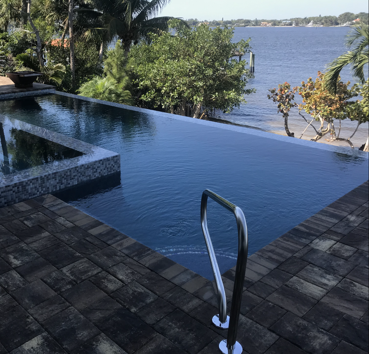A large swimming pool with a view of the ocean