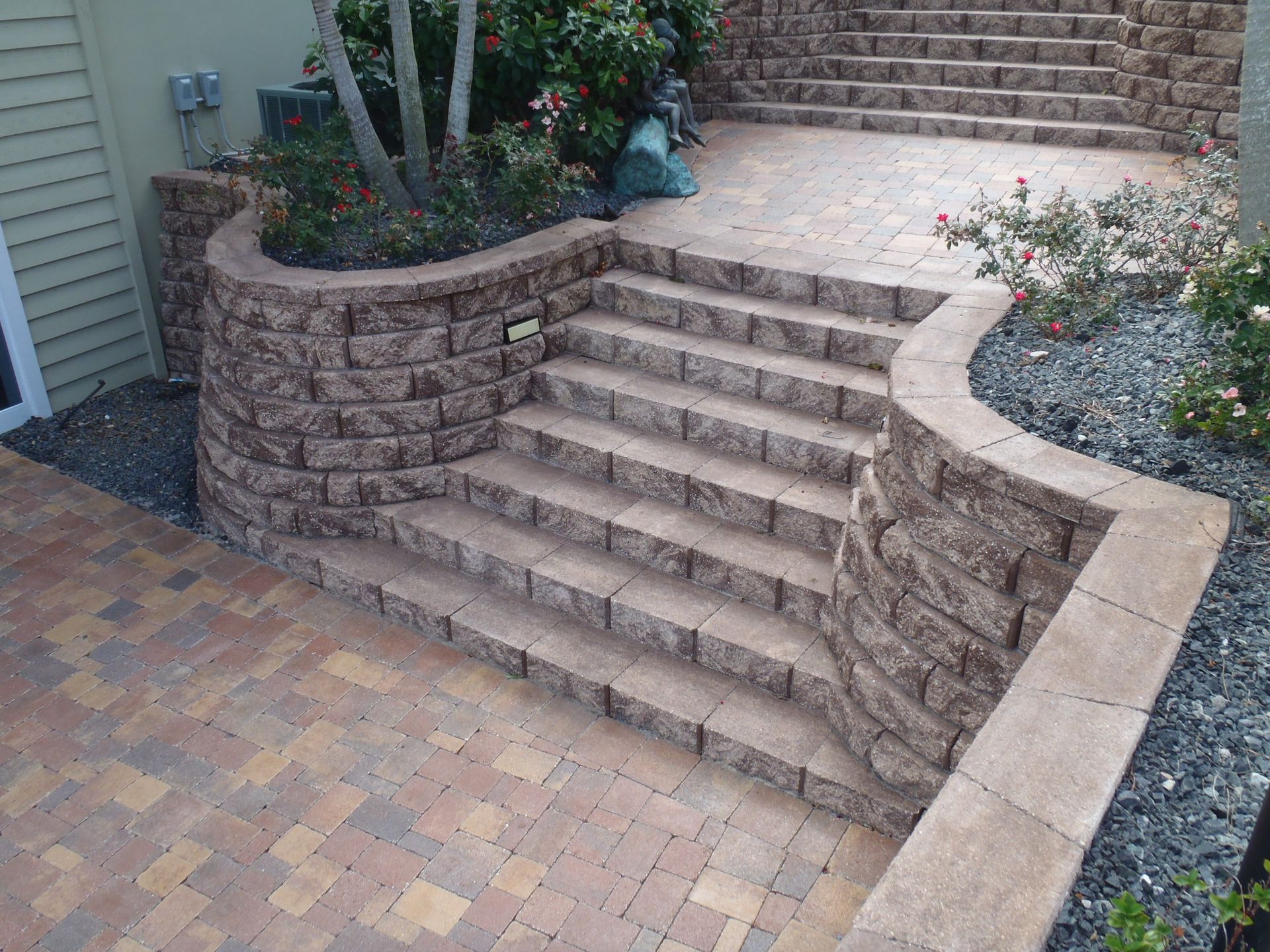 A set of stairs leading up to a brick wall.