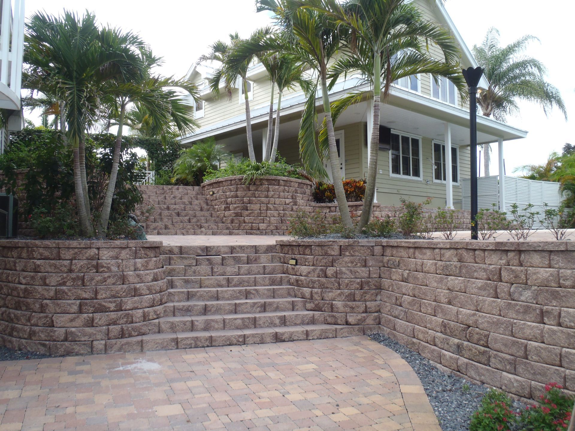 A house with a brick wall and stairs leading up to it