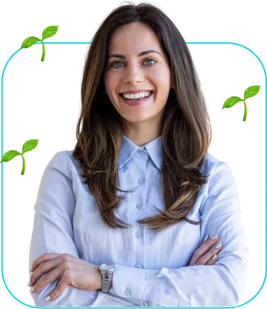 Smiling person in a light blue shirt with arms crossed, framed by green leaves on a white background