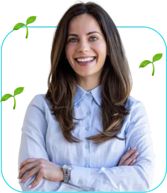 Smiling person in a light blue shirt with arms crossed, framed by green leaves on a white background
