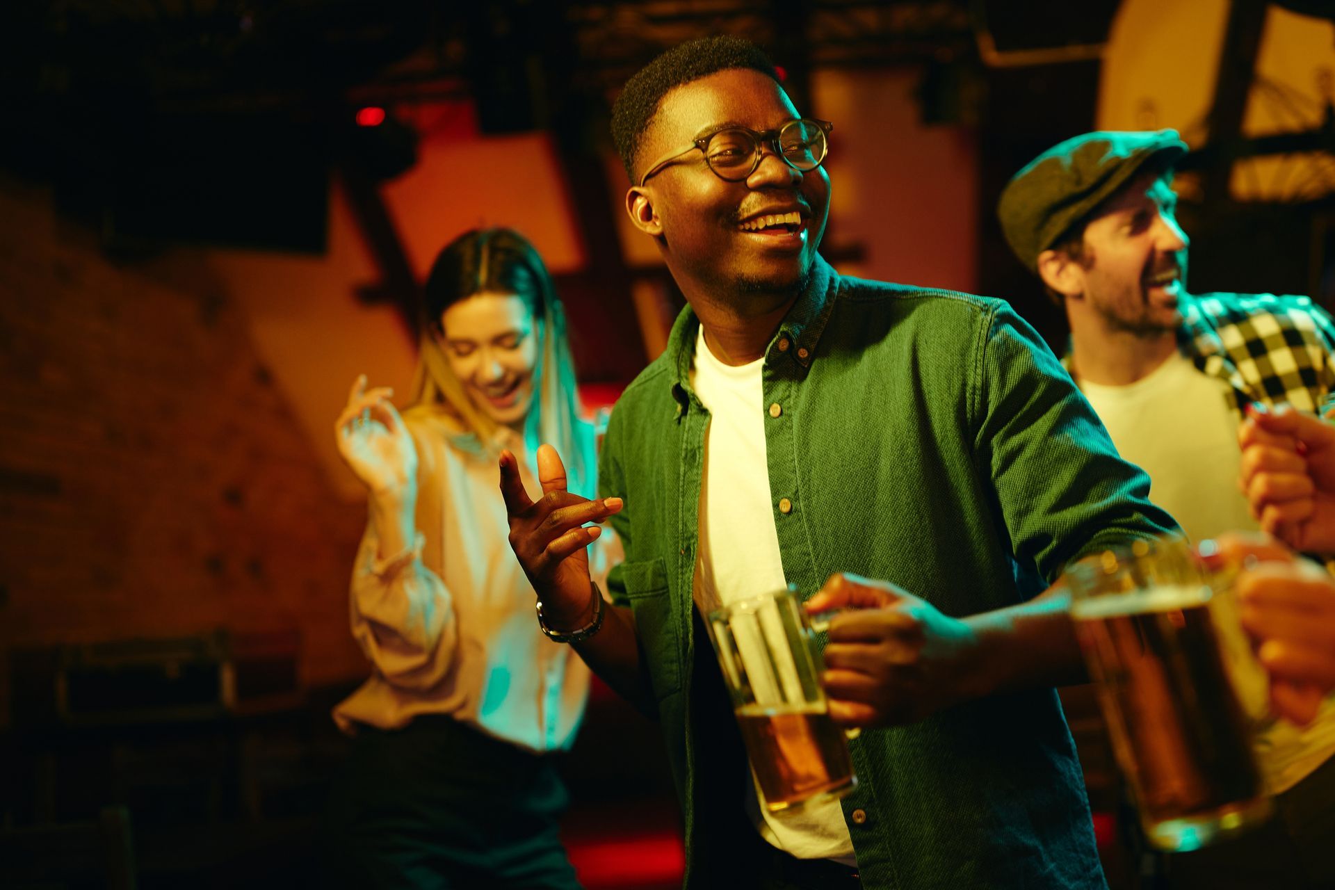 People dancing and drinking at a bar