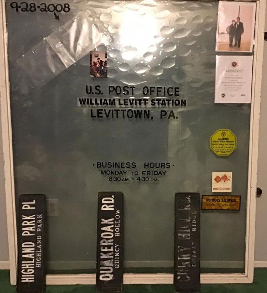US Post Office sign for William Levitt Station, Levittown, PA, with vintage street signs in front