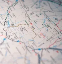 Close-up of a printed road map with red and blue route lines and place names