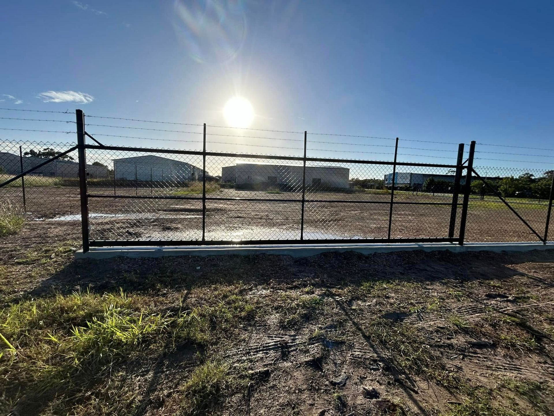 Chain-link Fence With Barbed Wire in Front of a Building — The Fence Place in Kawana, QLD