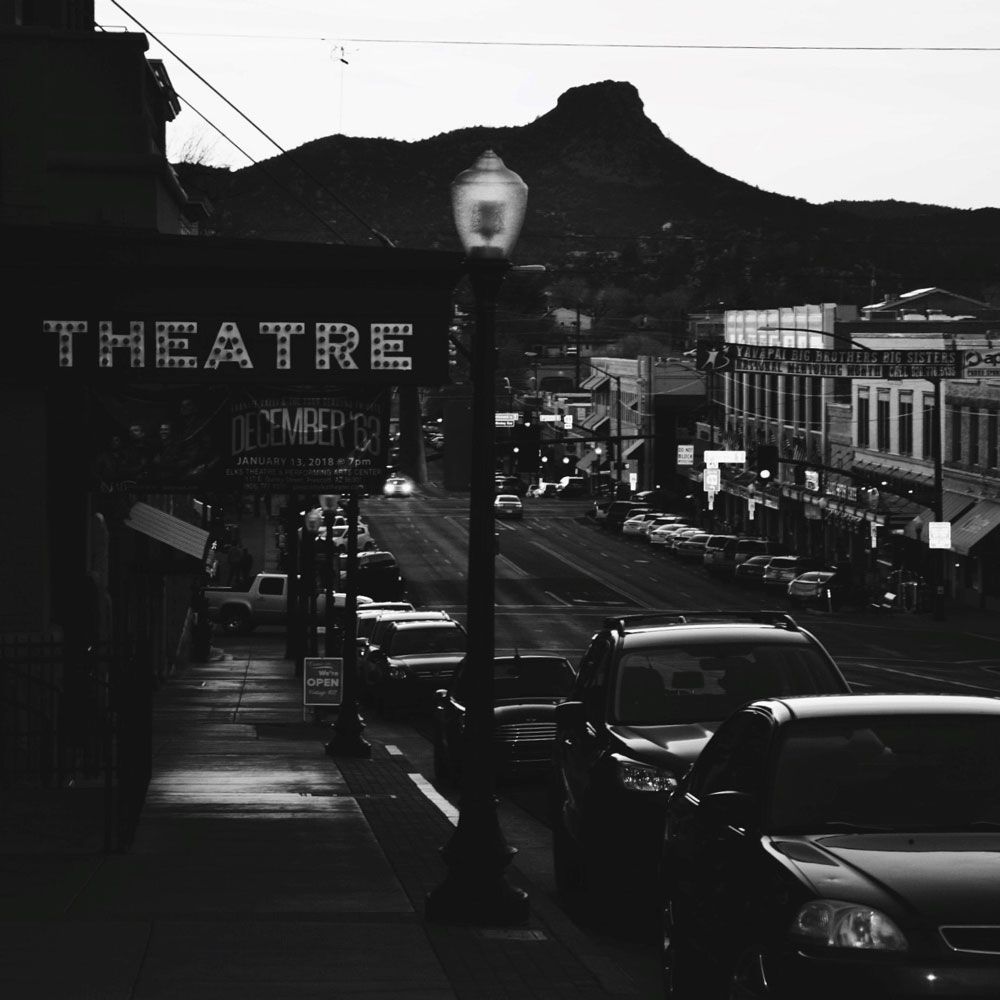 Black and white photo of a street in a town, with