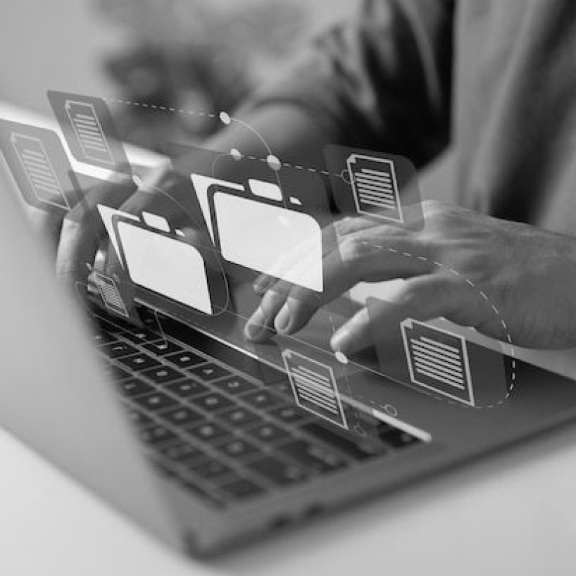 Hands typing on a laptop with floating folder and document icons, suggesting digital file management