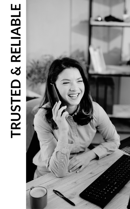 Smiling woman at desk using a phone, with “TRUSTED & RELIABLE” text beside her