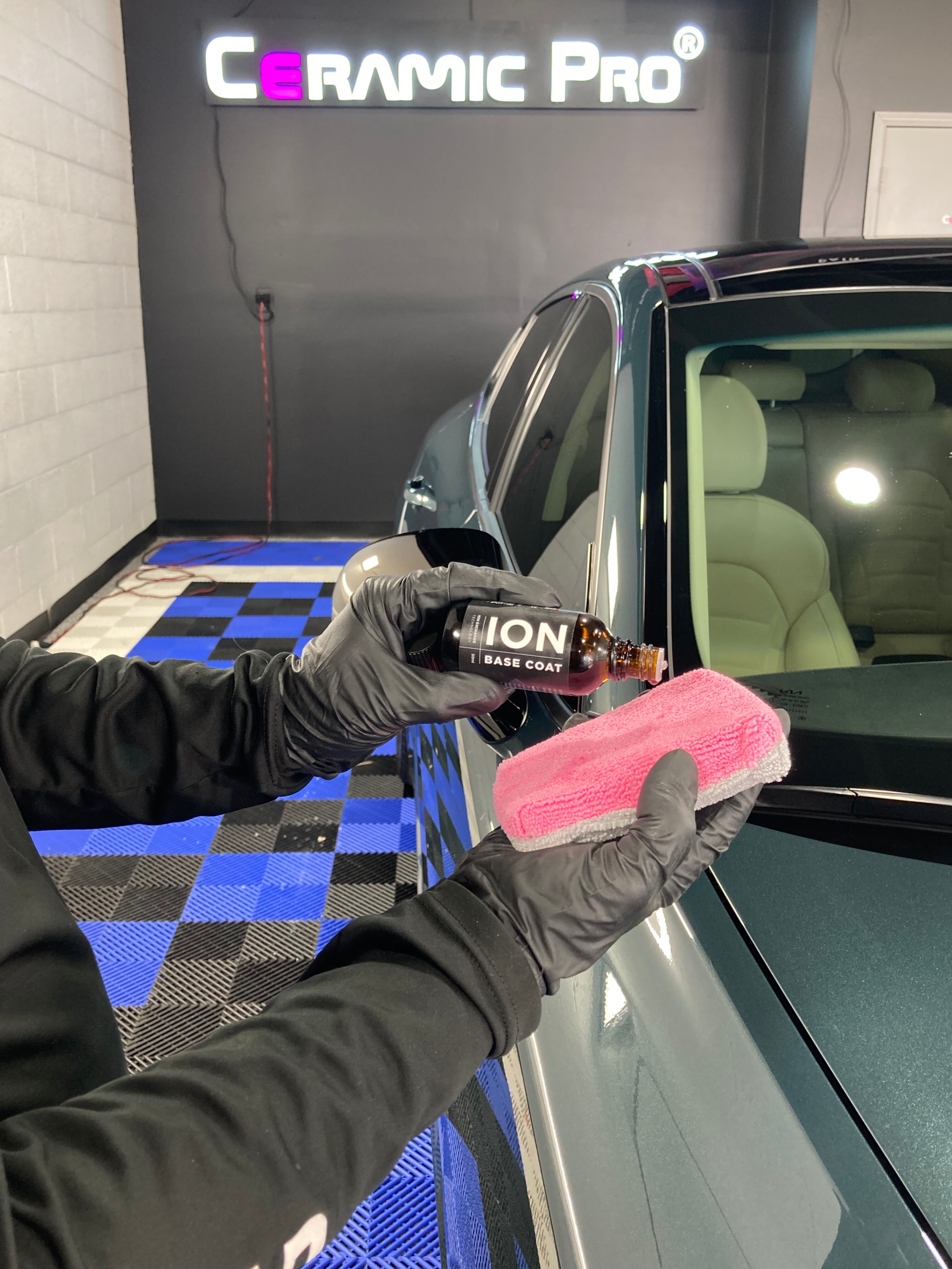 car specialist applying ceramic coating