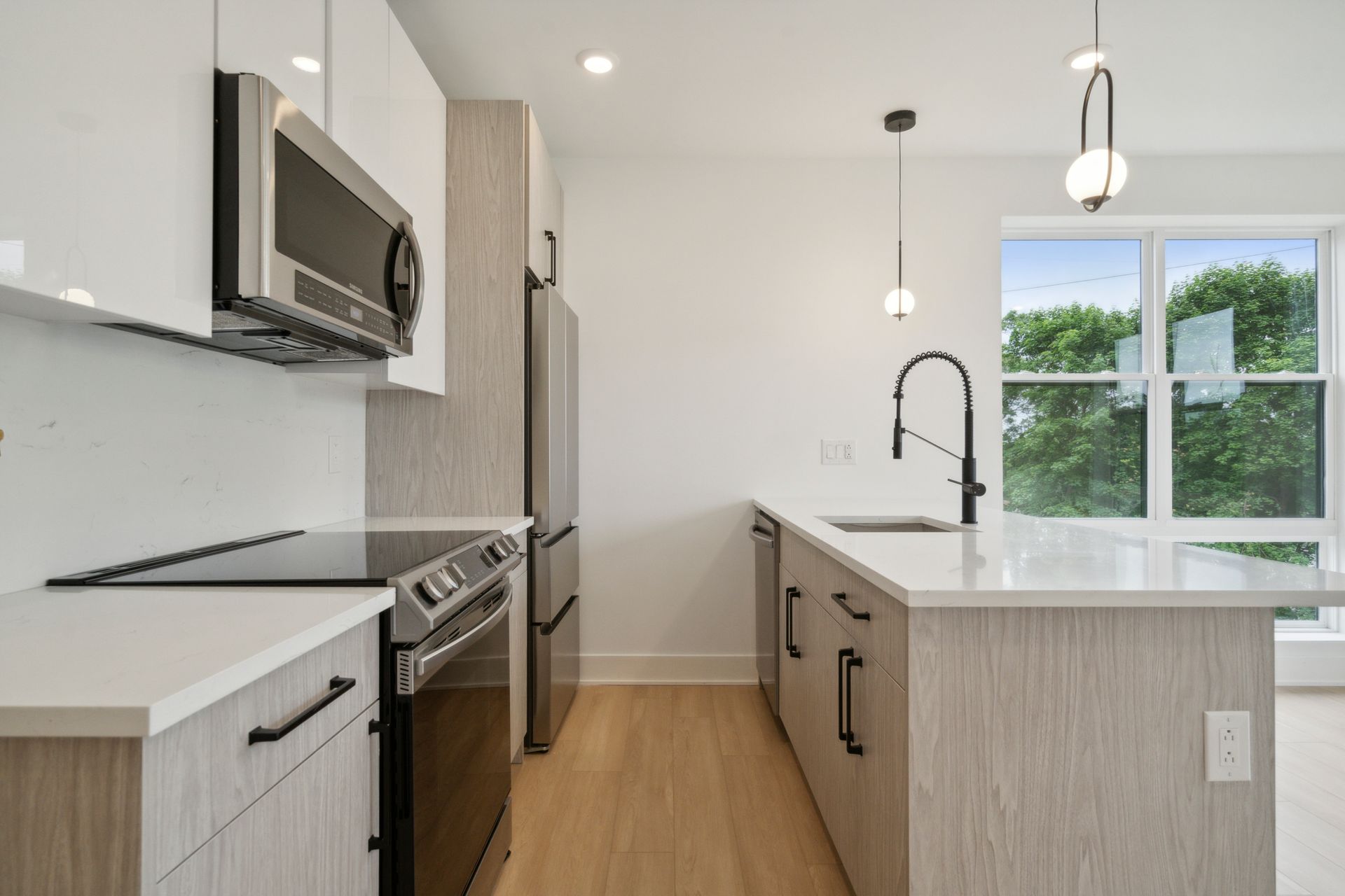 Open kitchen and living area with updated appliances at 881 N 40th St West Philly apartment