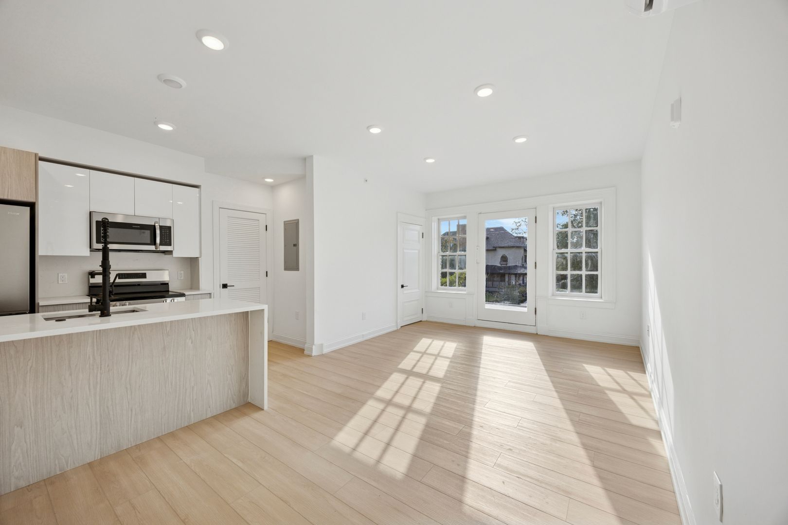 Modern kitchen with wood cabinets and stainless appliances at 6399 Drexel Road and Natural Light