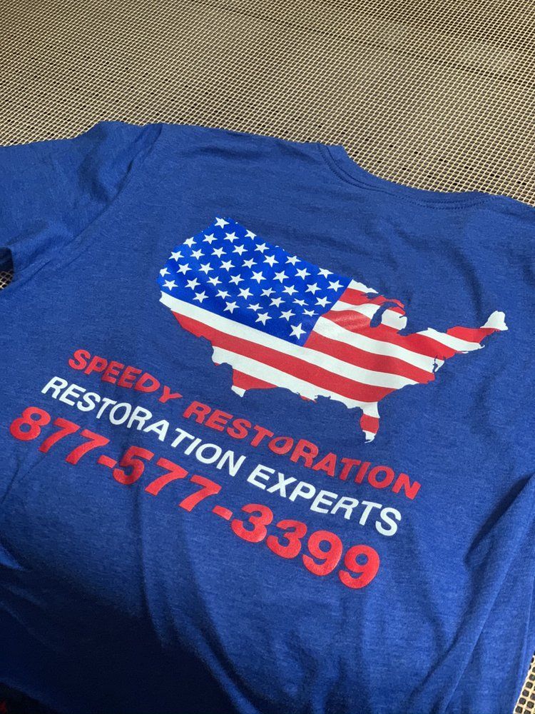 A blue shirt that says speedy restoration experts on it