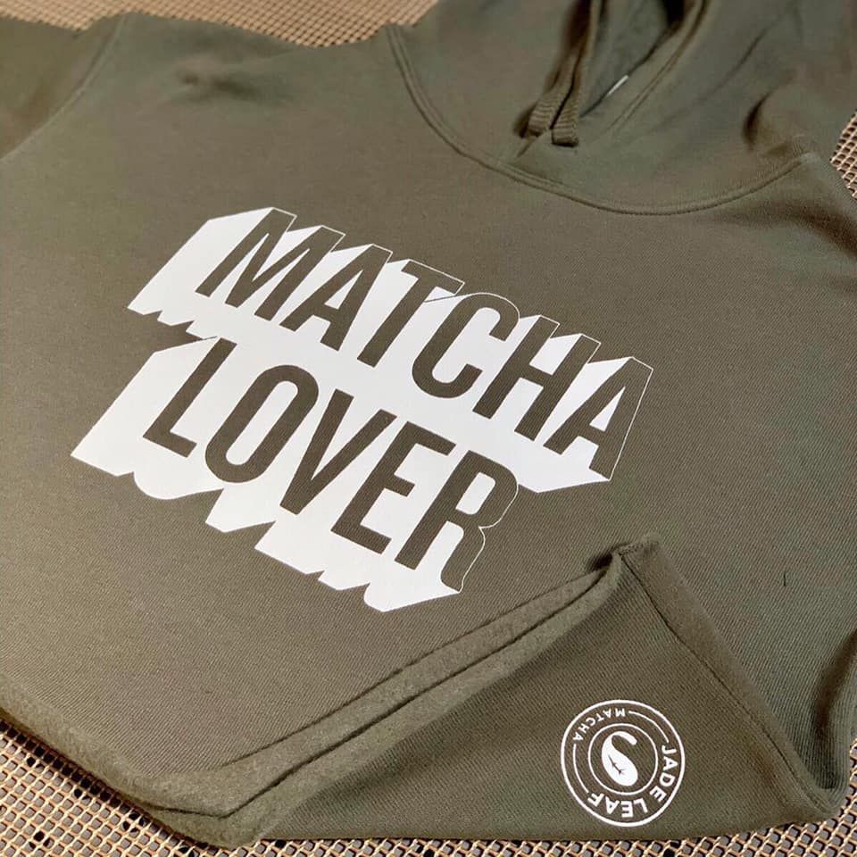 A green hoodie that says matcha lover on it