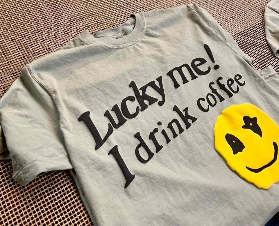 A t-shirt that says lucky me i drink coffee