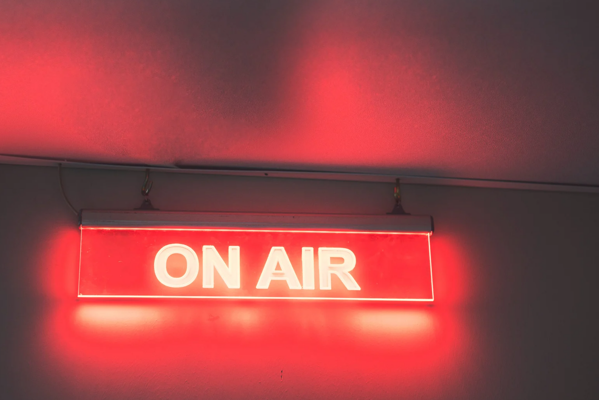 A red sign that says on air is lit up