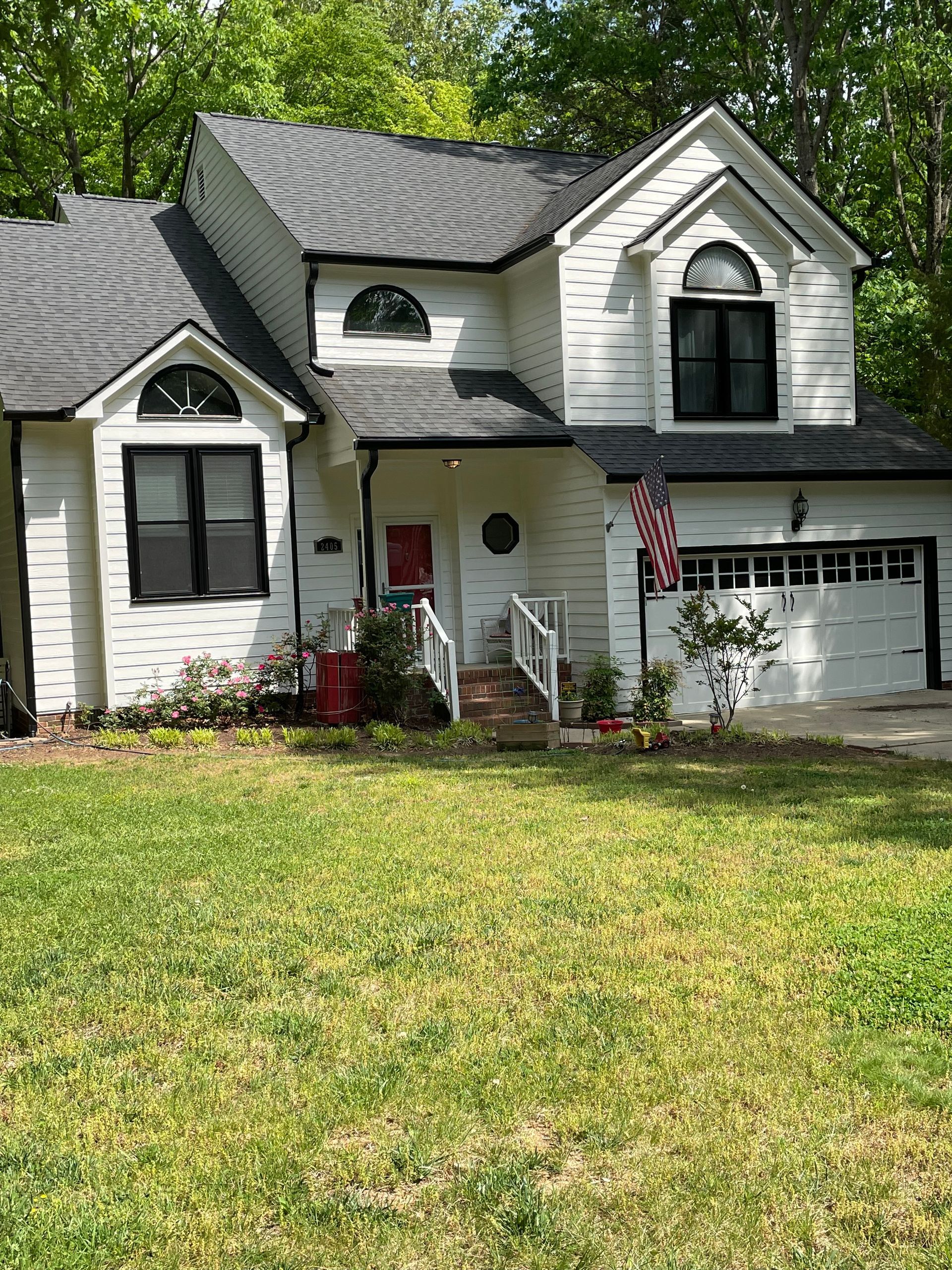 A large white house with a gray roof