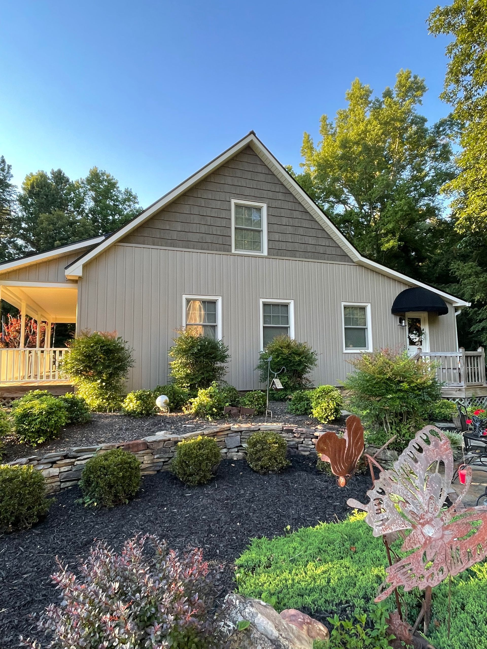A house with a lot of plants in front of it