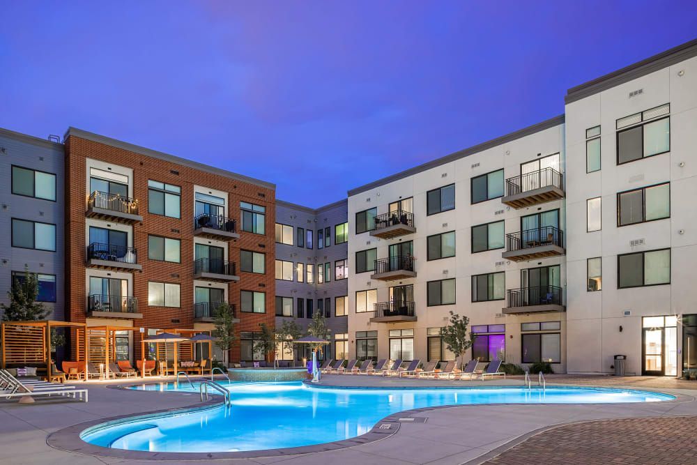 Apartment swimming pool at night at Marq Iliff Station in Aurora, CO.
