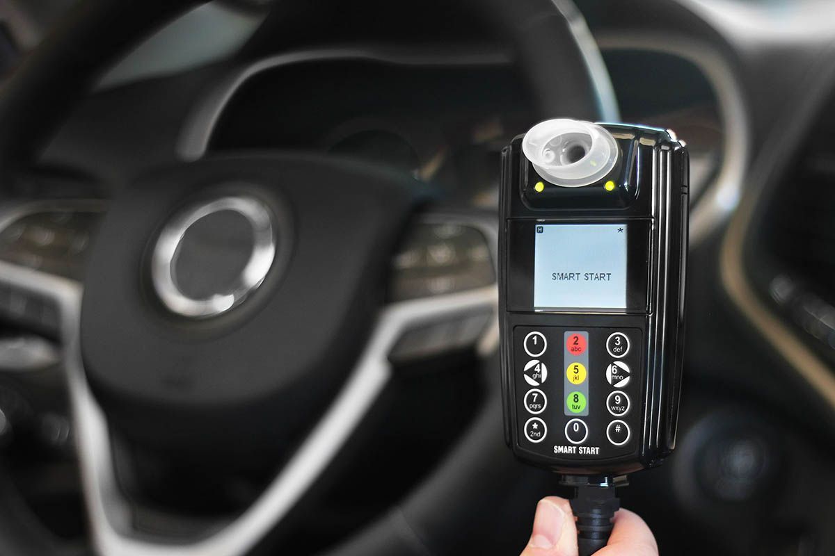 Hand Pressing A Car Key Fob Beside A Black Car Door — Secure Diesel & Automotive in Ryan, QLD