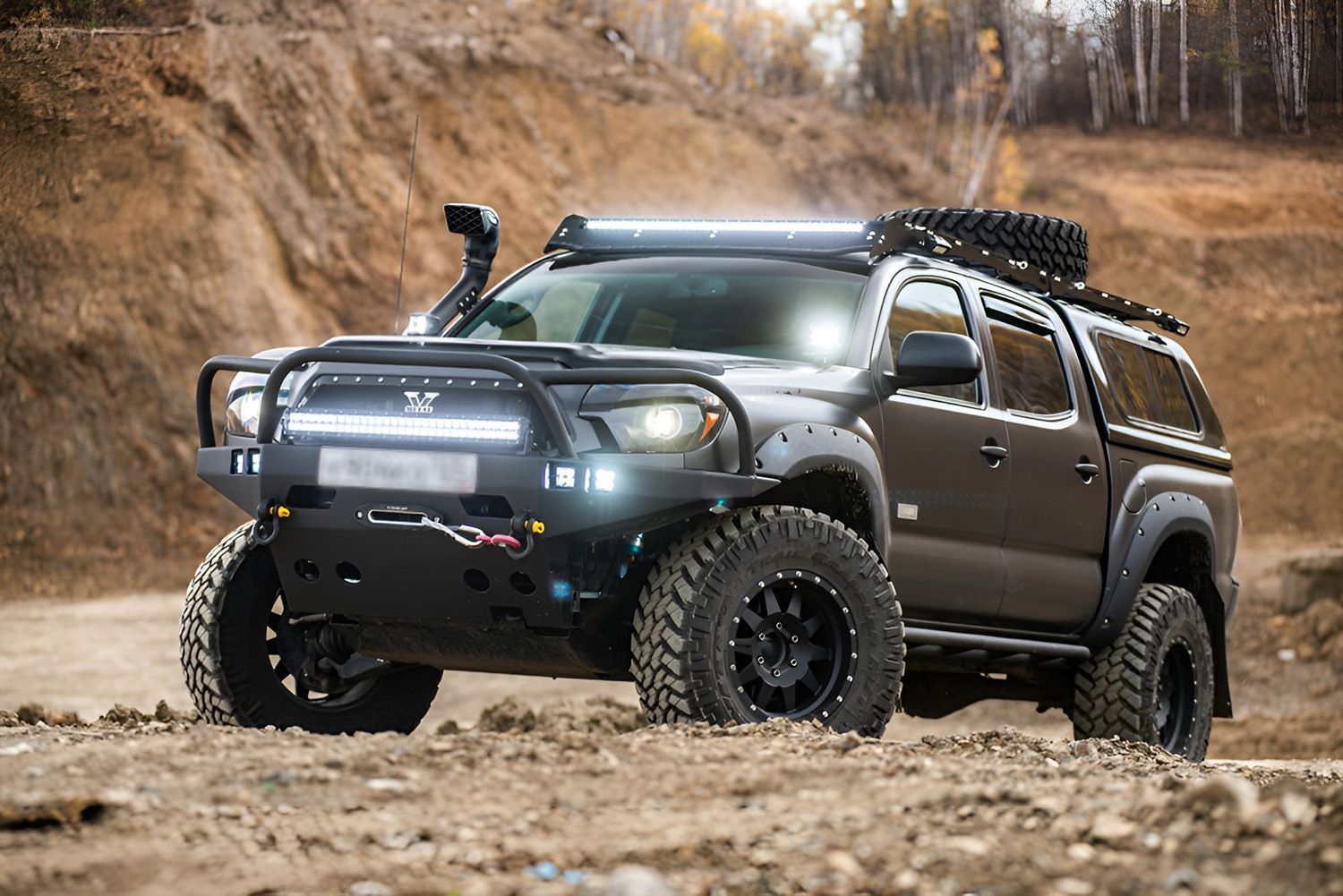 A Matte Black Off-Road Truck On Rocky Terrain