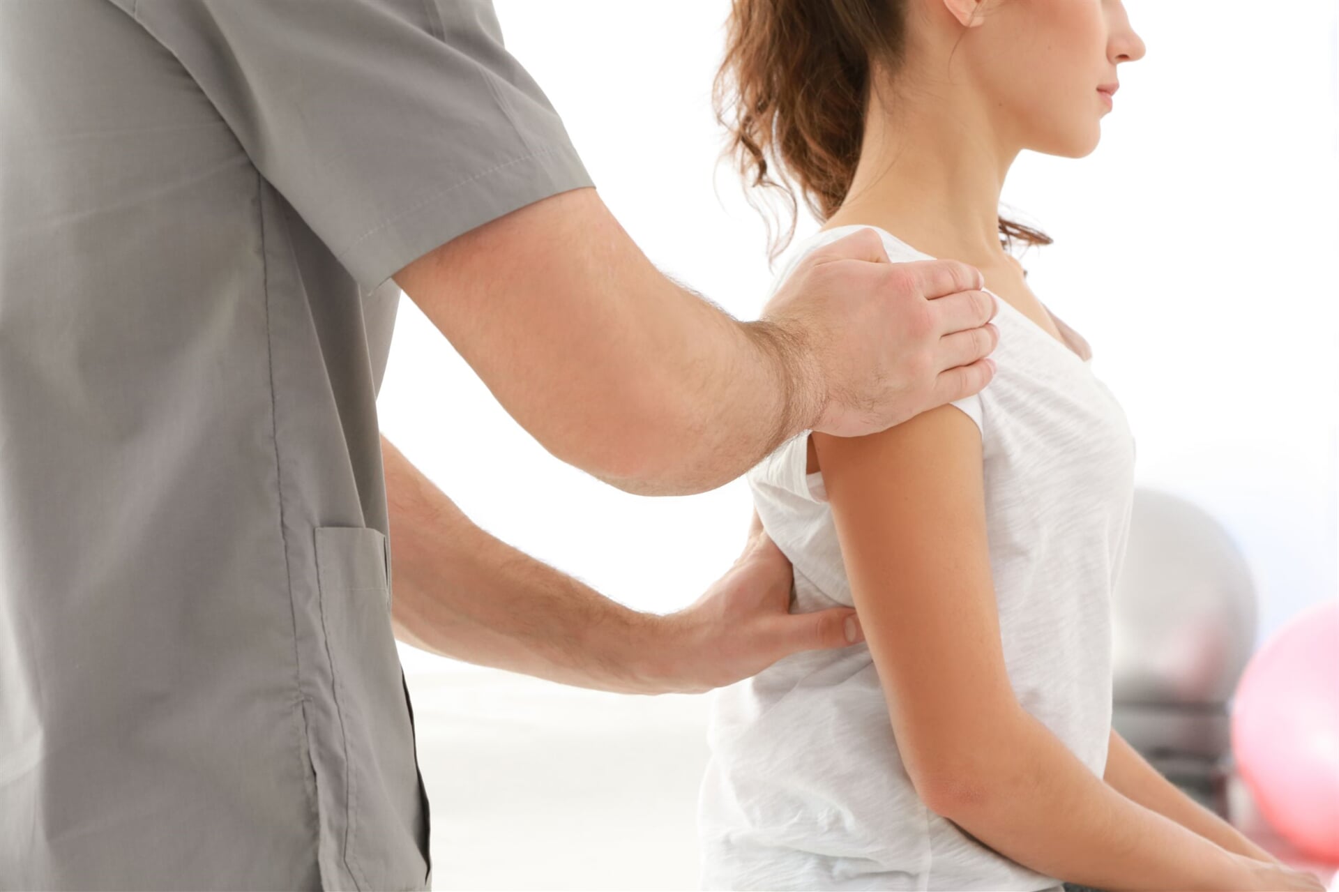 Physical Therapist Fixing Woman's Spine Deformation — Goulburn Physiotherapy Centre in Goulburn, NSW