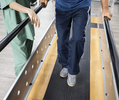 Man Supports a Senior on Treadmill — Goulburn Physiotherapy Centre in Goulburn, NSW