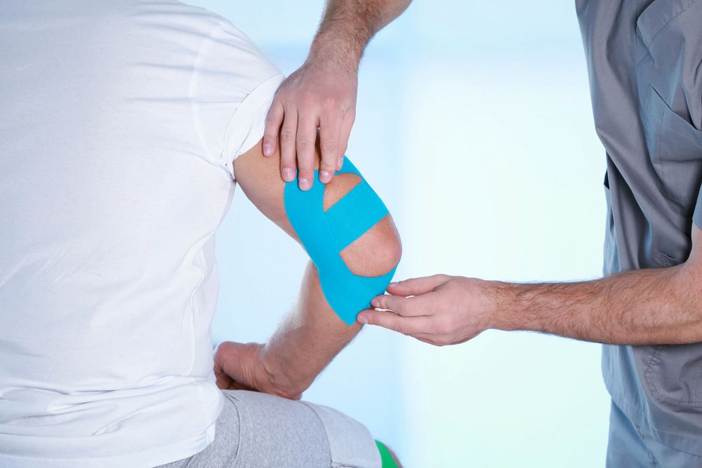 Person Receiving Kinesiology Tape on Elbow From a Healthcare Professional — Goulburn Physiotherapy Centre in Goulburn, NSW