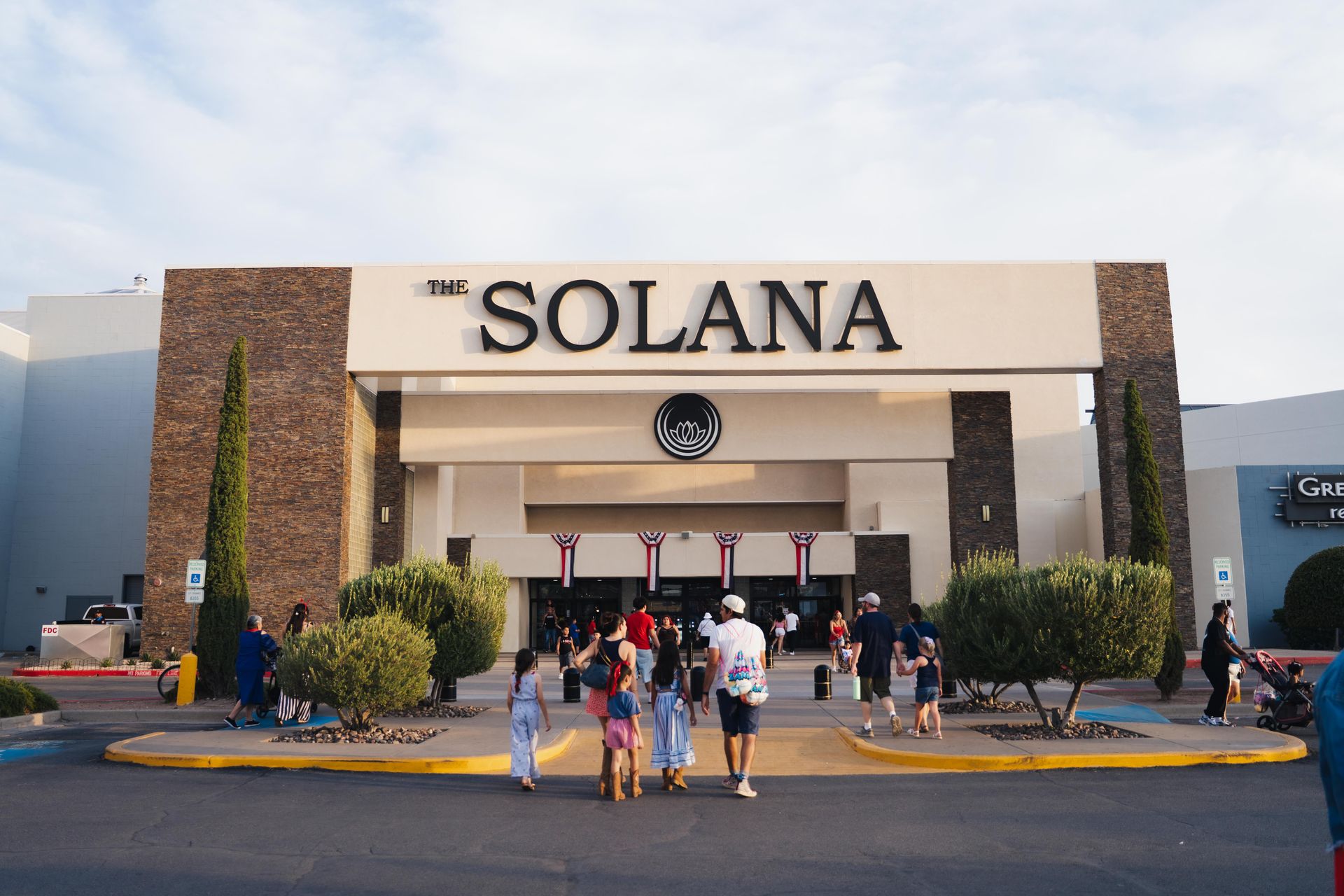 The Solana building entrance with people walking outside at sunset