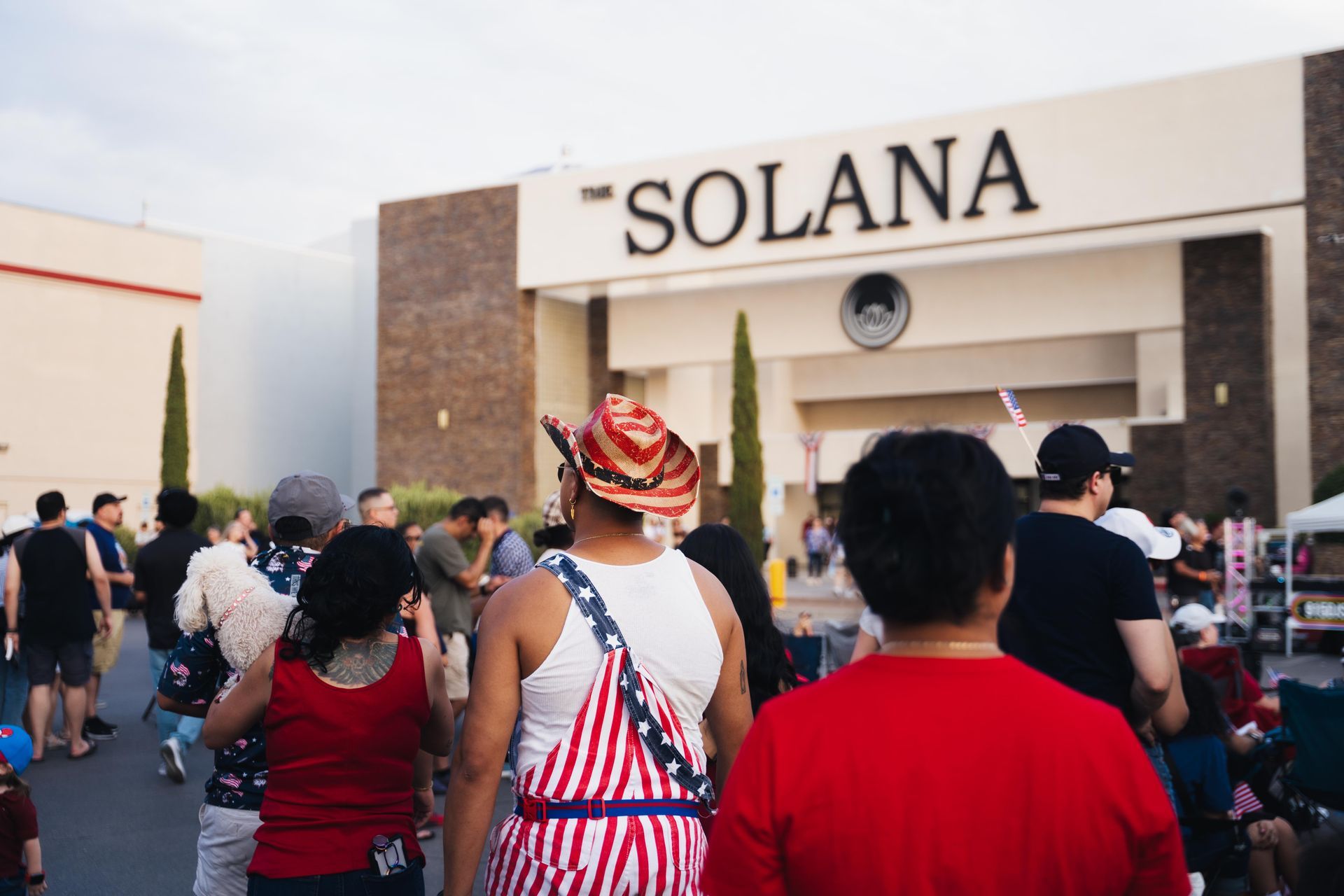 Crowd approaching Solana entrance, with people in casual clothes facing the building sign.