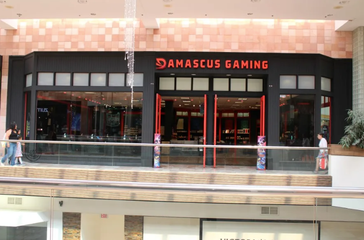 Damascus Gaming storefront with black facade and red sign in a shopping mall corridor