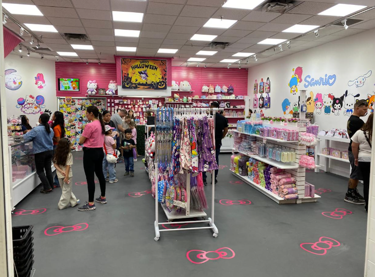 Brightly lit toy store aisle with shoppers, colorful shelves, and heart decals on the floor