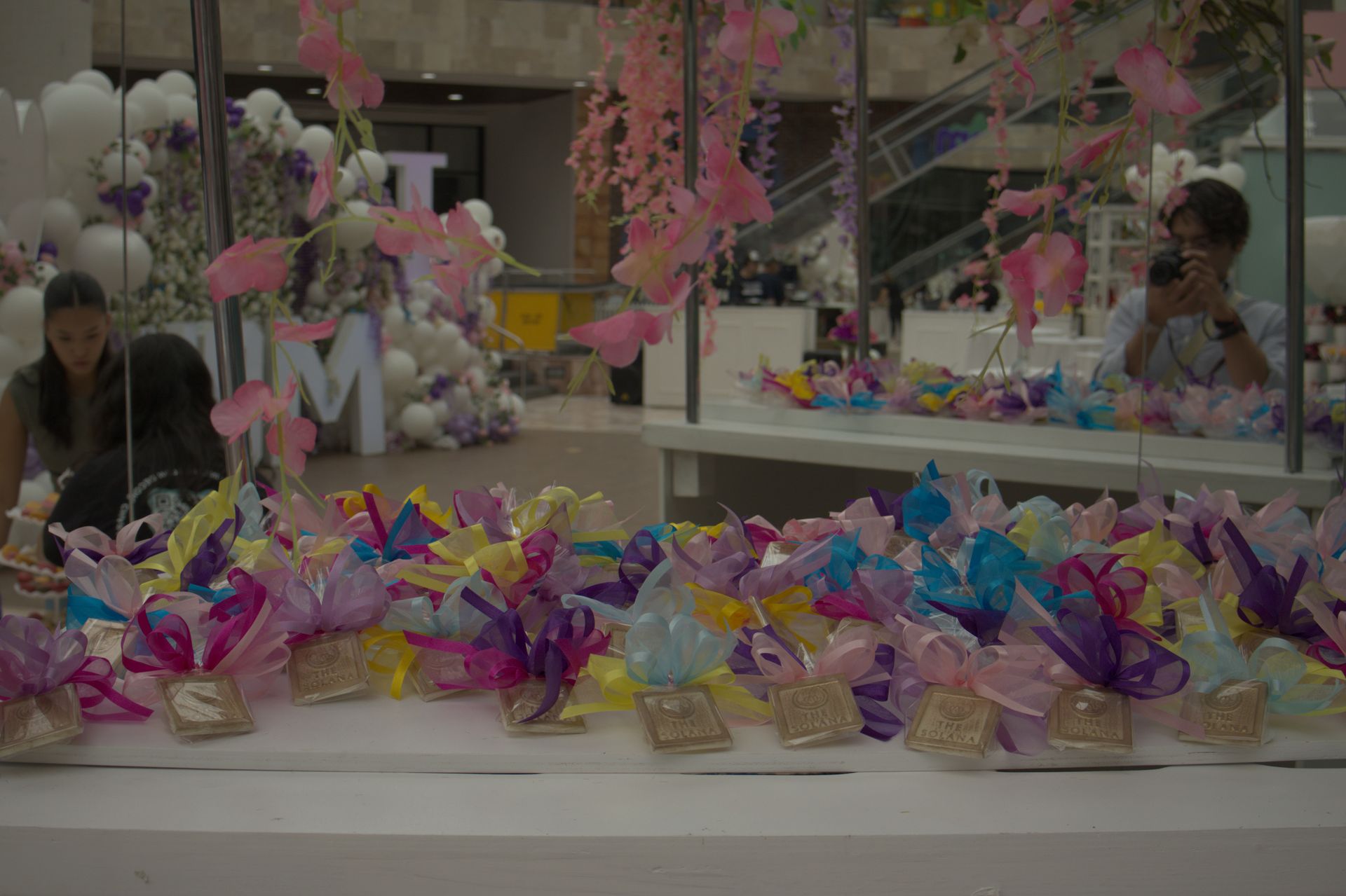 Colorful pinwheel craft display on a table at an indoor market or fair booth