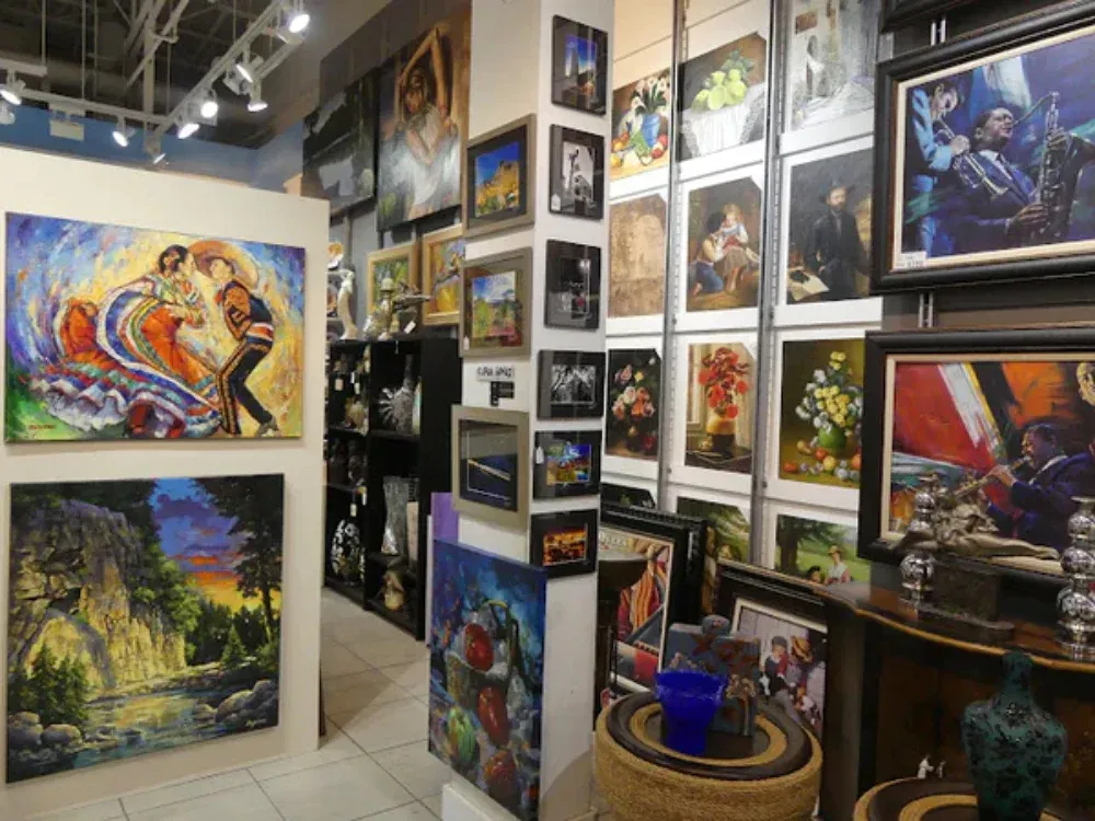 A room with a lot of paintings on the wall