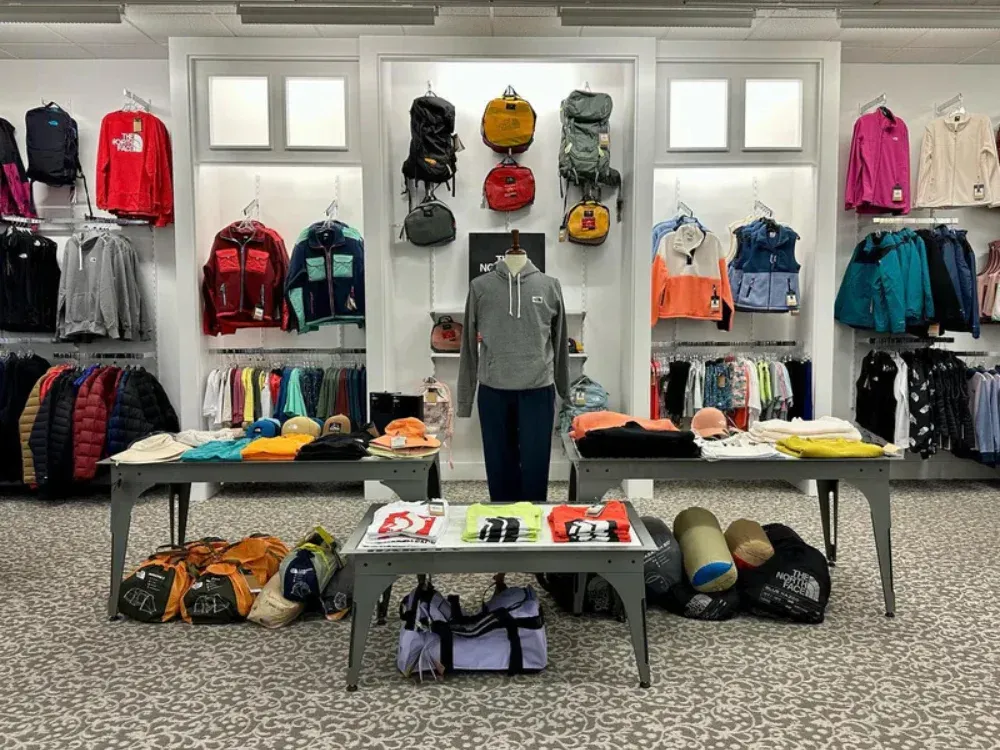 A store filled with lots of clothes and backpacks.