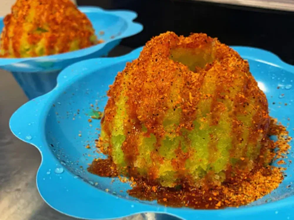 A close up of a dessert on a blue plate on a table.