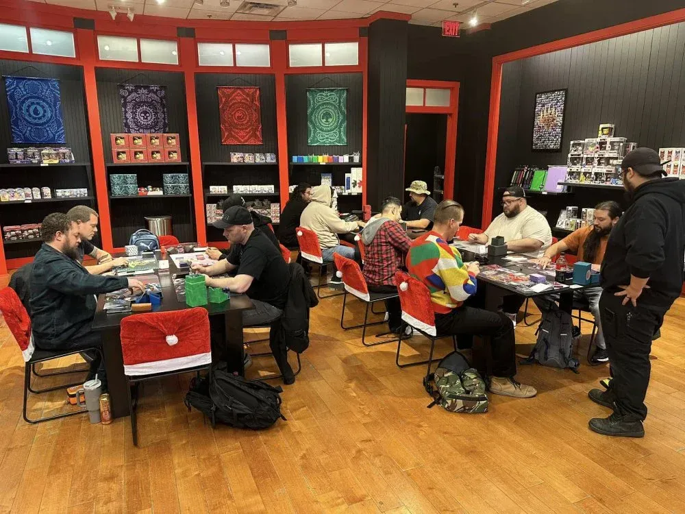 A group of people are sitting at tables in a room playing a game.