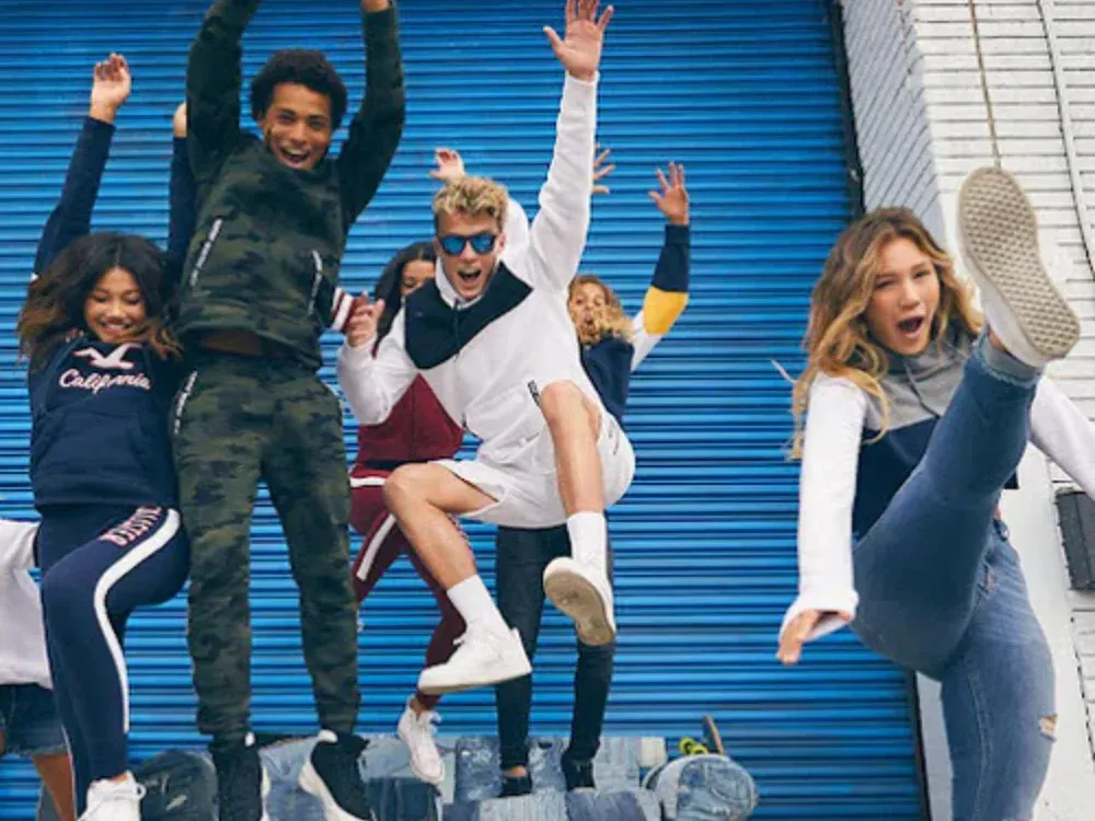 A group of young people are jumping in the air.