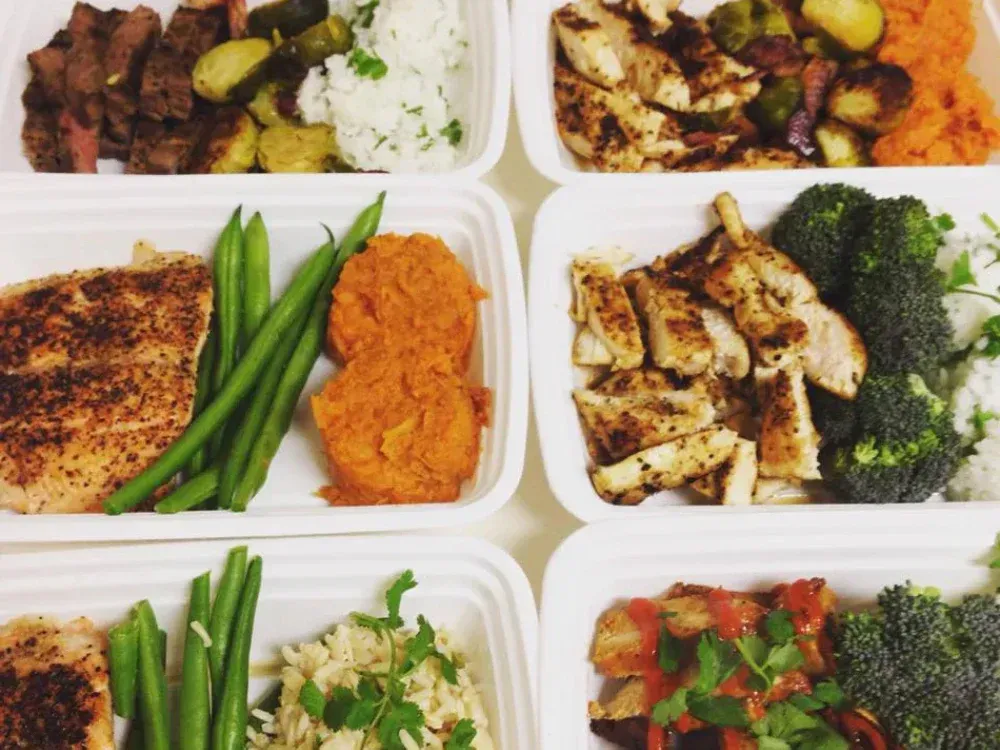 A variety of healthy foods in plastic containers on a table
