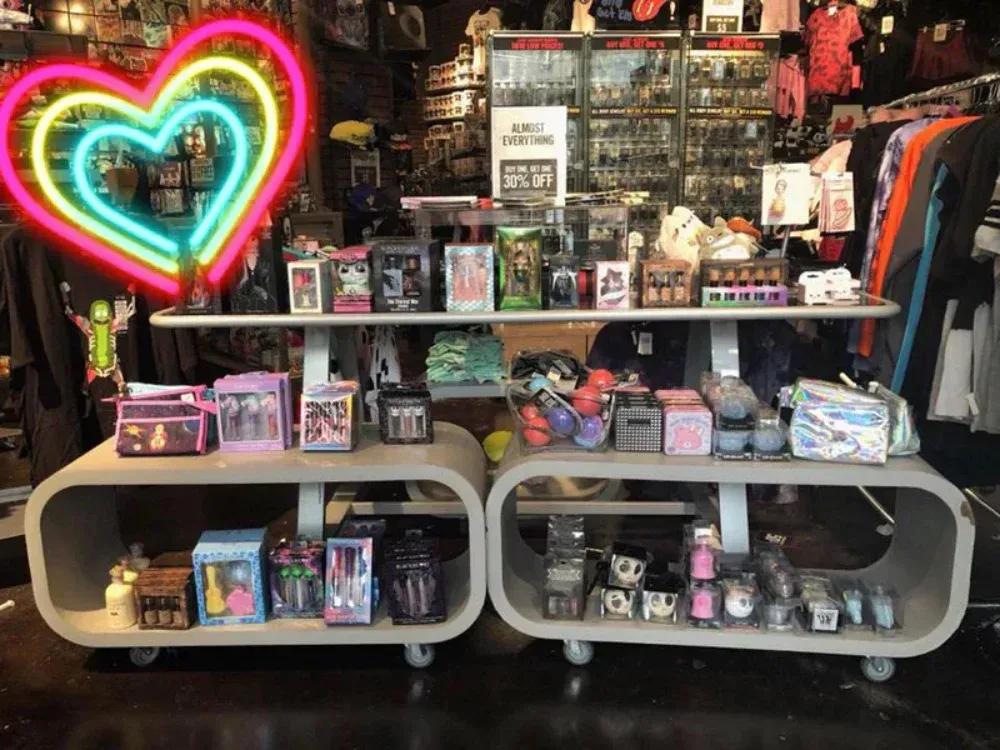 A store display with a neon heart in the background