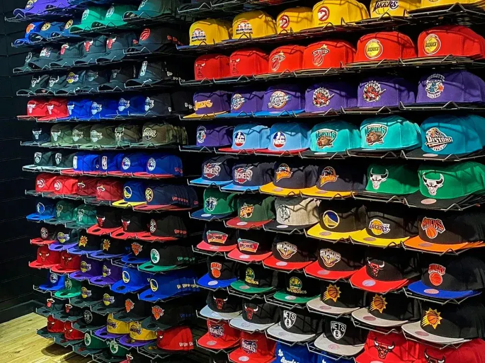 A wall filled with lots of different colored hats.