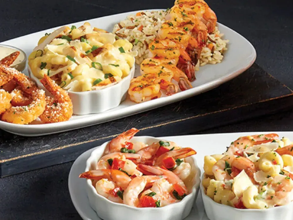 A plate of food with shrimp and macaroni and cheese on it