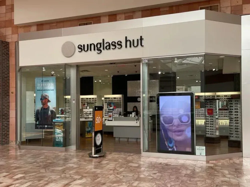 A sunglass hut store is located in a mall.