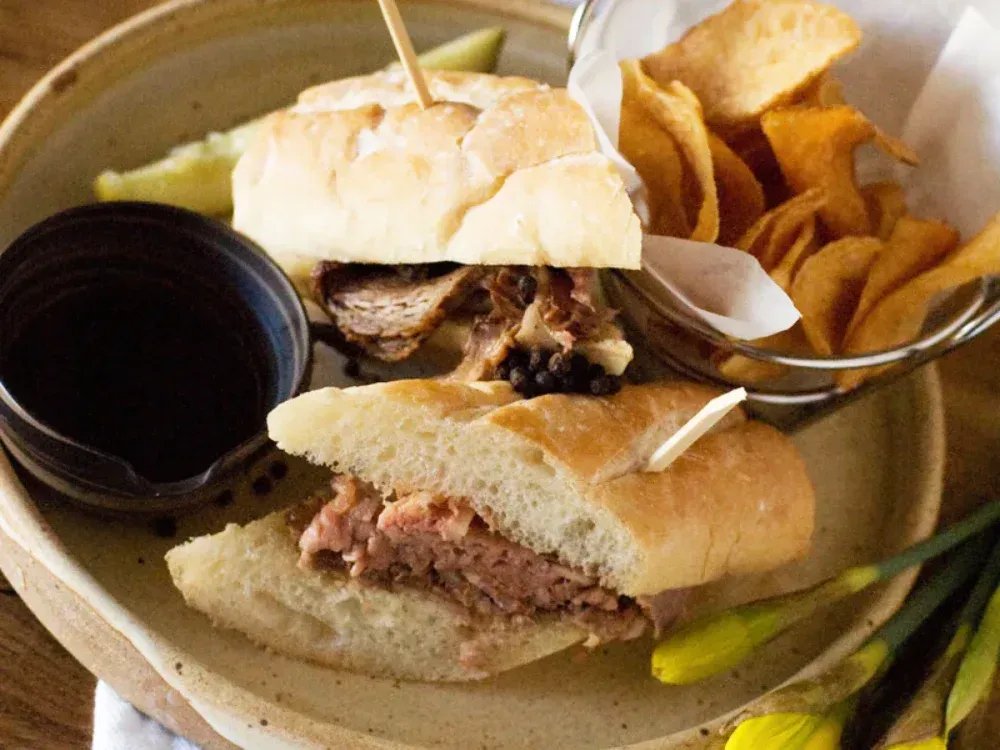 A plate of food with a sandwich and chips on it