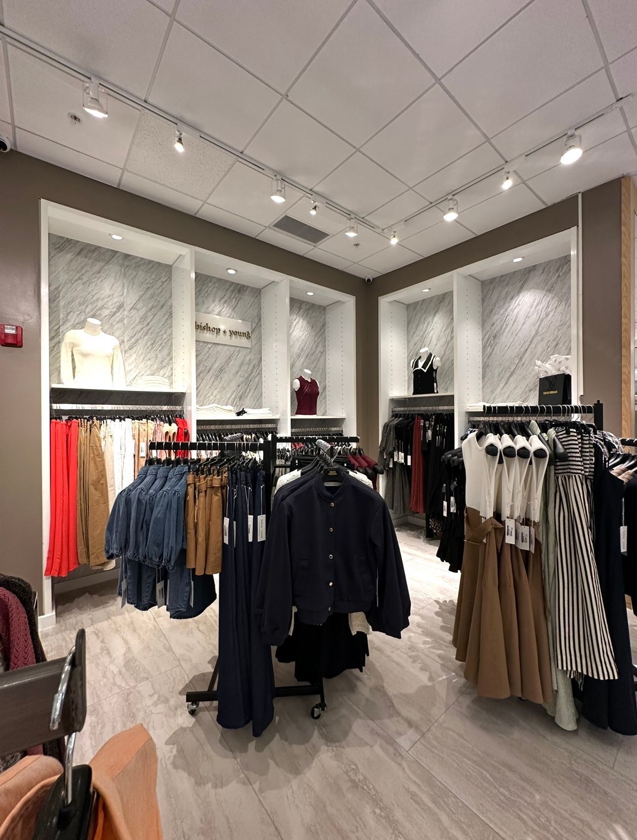 A store filled with lots of clothes and tables.